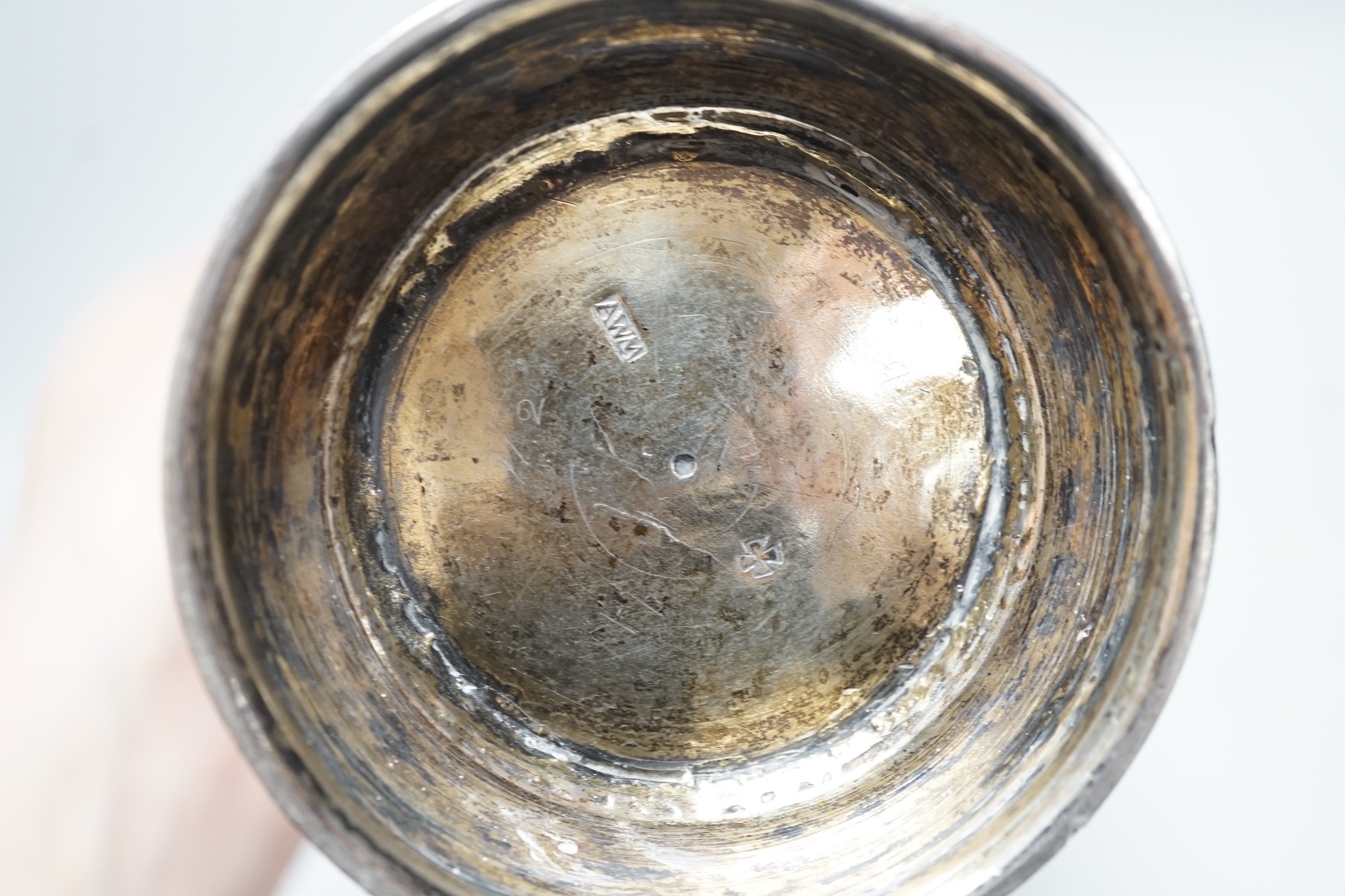 A 19th century Swiss? embossed parcel gilt white metal flared vase, maker's mark AWM, engraved with two armorials, height 17cm, 10.8oz.